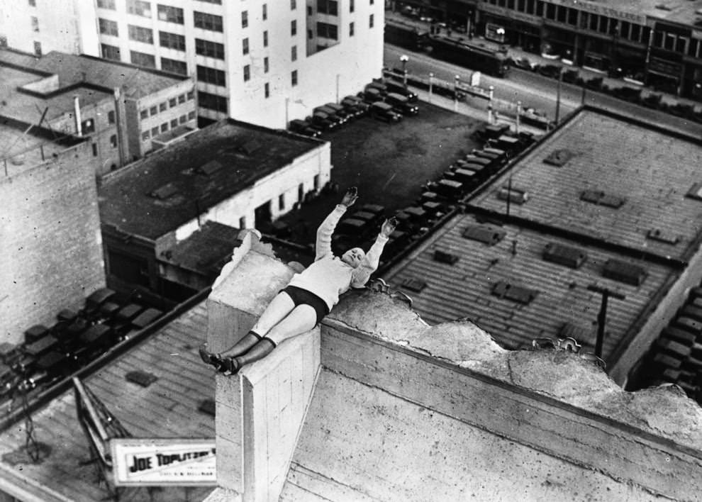 Daredevil Gladys Roy trains for her flying acrobatics by balancing on the rooftop of a skyscraper in Los Angeles, 1925