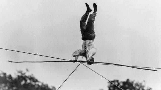 German circus performer Alsons Tonelli performs a headstand on a rope 120 feet from the ground at Battersea Festival Gardens, London