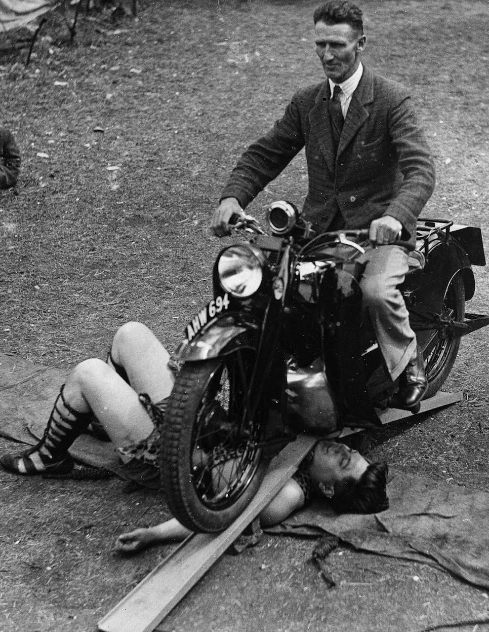 Samson Brown, the world’s strongest man, lets a motorcycle run over him, 1934
