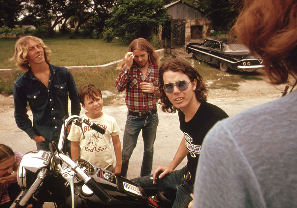 Motorcyclist loading his possessions onto a truck with the help of his friends in Leakey, May 1973. (Marc St. Gil/NARA)