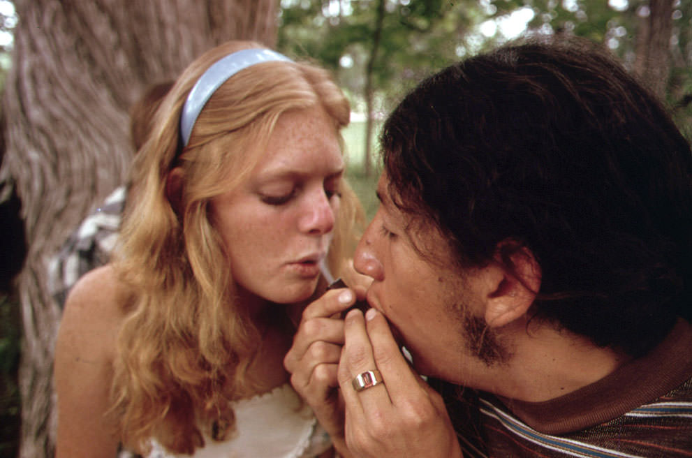 A young man and woman smoke pot during an outing near Leakey, Texas, (photo taken with Permission), May 1973. (Marc St. Gil/NARA)