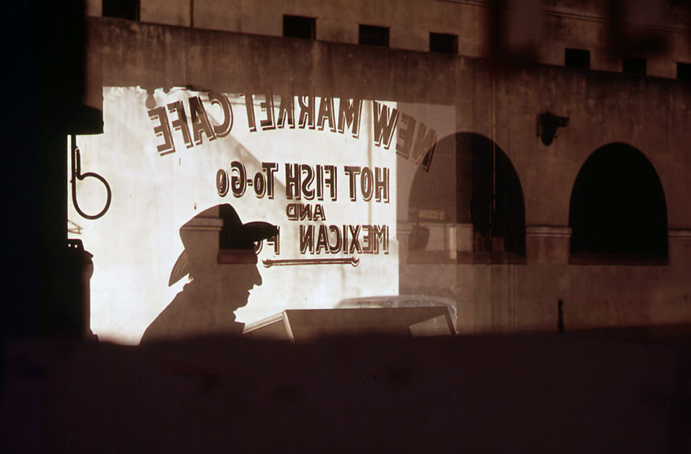 Customer's shadow reflected in window of New Market Cafe in the old Mexican market area of San Antonio, in November of 1972. (Bob Smith/NARA)