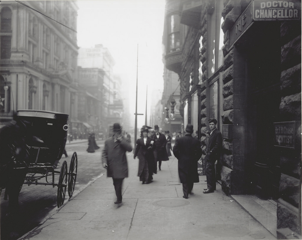Pedestrians on the sidewalk near the intersection of Sixth and Locust Streets, ca. 1900s