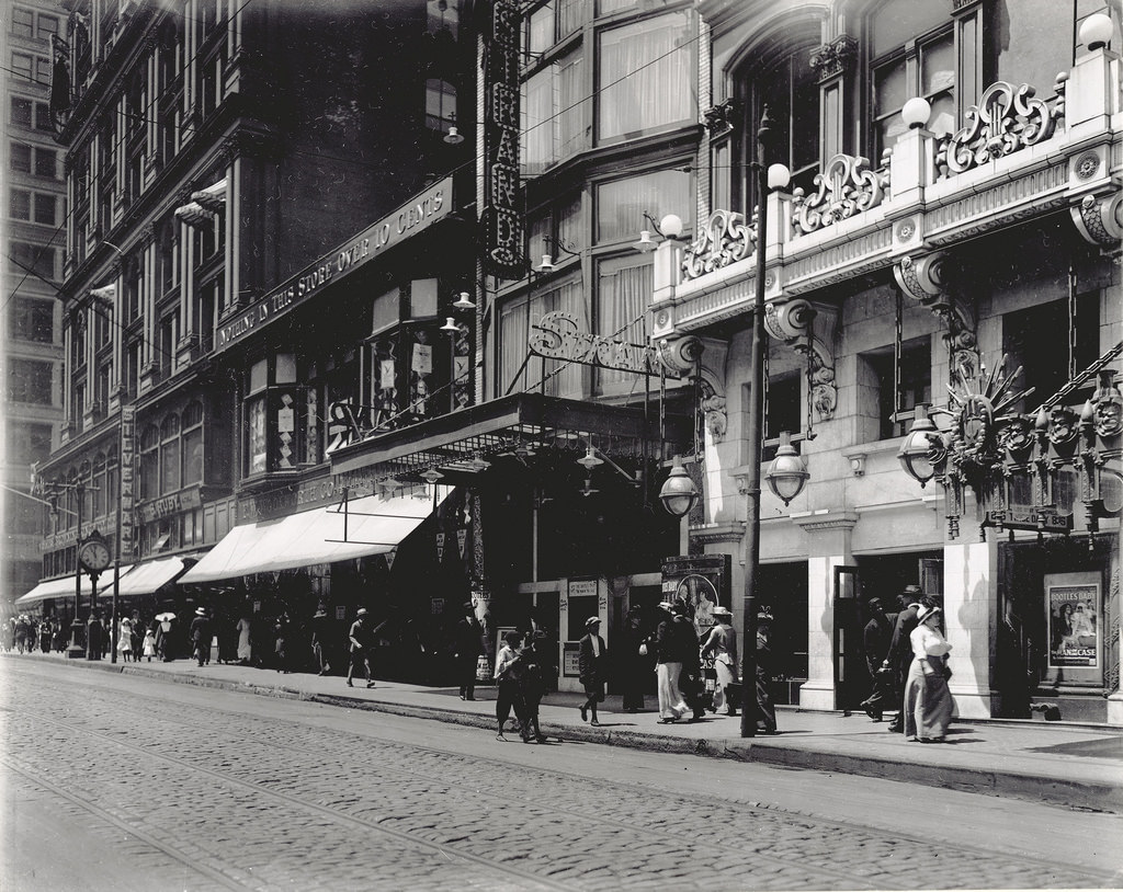 Pedestrians passing the F.W. Woolworth Company store at 413 N. Sixth Street and the Strand Theater box office, 1914