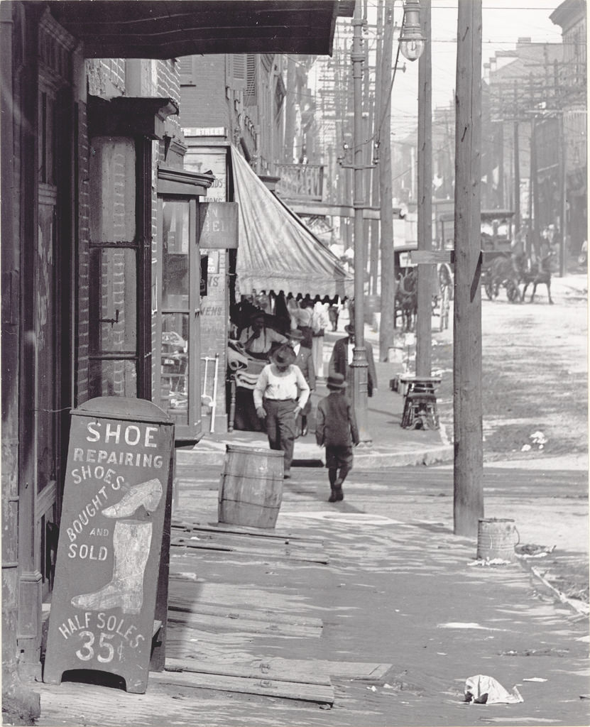 Sidewalk scene on a street in St. Louis, ca. 1900s