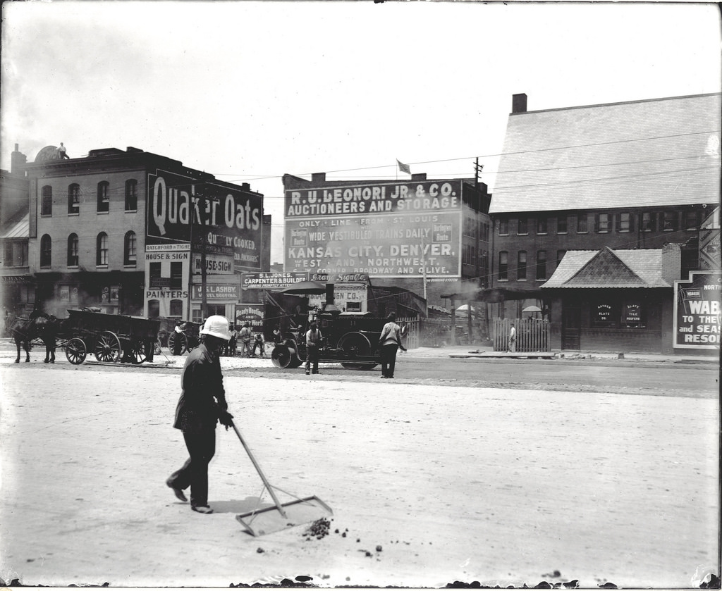 Street cleaner at work on Twelfth Street between Olive and Locust Streets, 1909