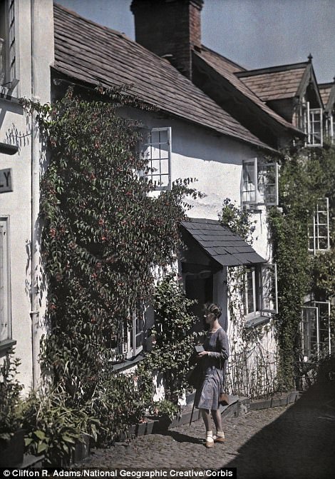 A woman walks on the street in Clovelly, 1931