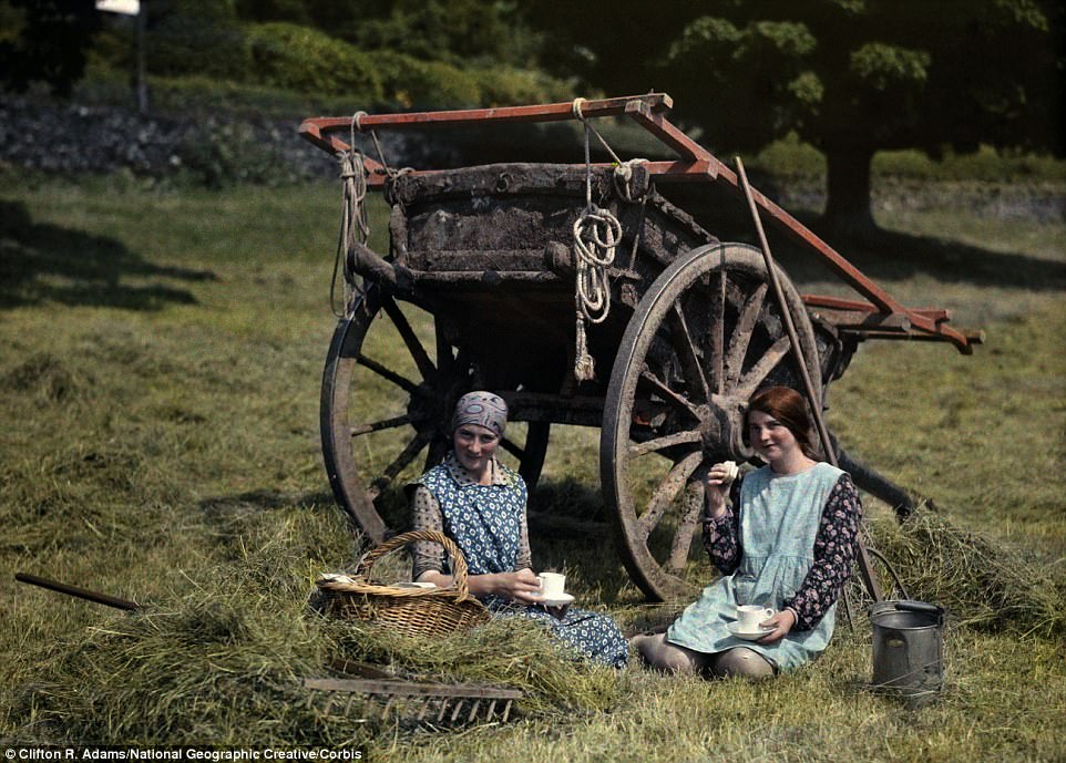 Two girls eat lunch in a hayfield near Hawkshead in Lancashire in 1929, which is now part of Cumbria