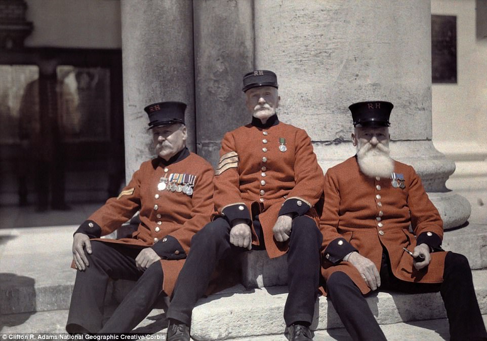 Veteran soldiers - known as Chelsea Pensioners - sit on the steps of the Royal Hospital Chelsea in London in 1928