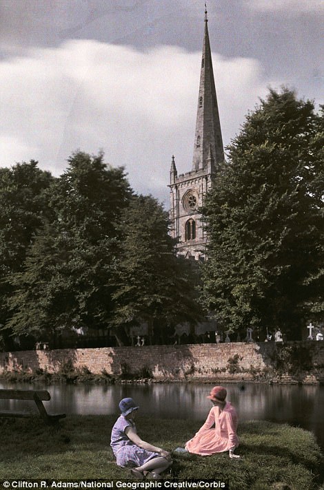 Women sit near the Avon River with Holy Trinity Church behind in Stratford in 1929