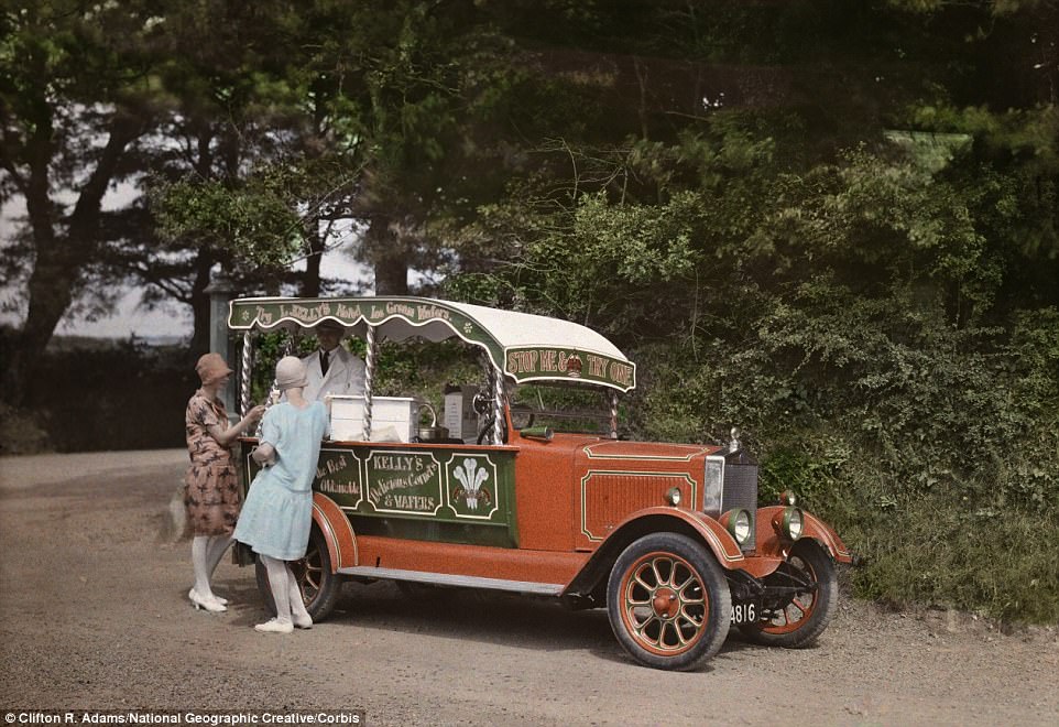Two women buy ice cream from a vendor out of his converted car in Cornwall in 1928