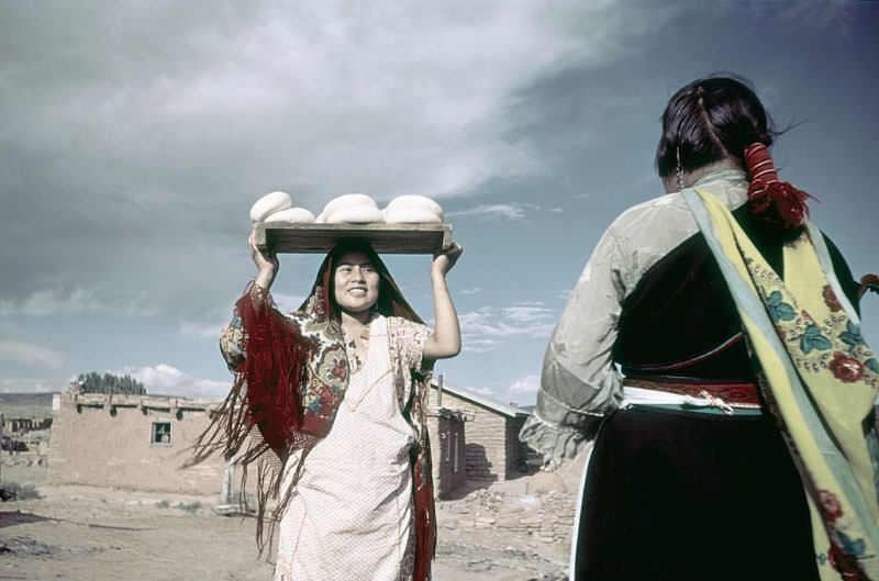 Pueblo women (probably from the Zuni tribe) bake bread.
