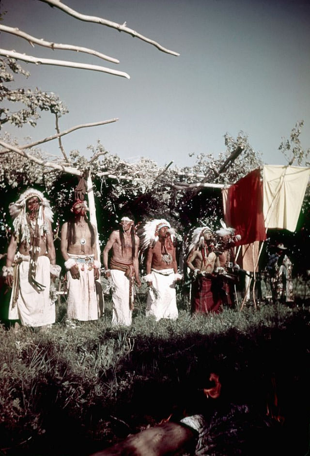 Native Americans (possibly from the Lakota Sioux tribe) blow Eagle bone Whistles while participating in the Sun Dance.