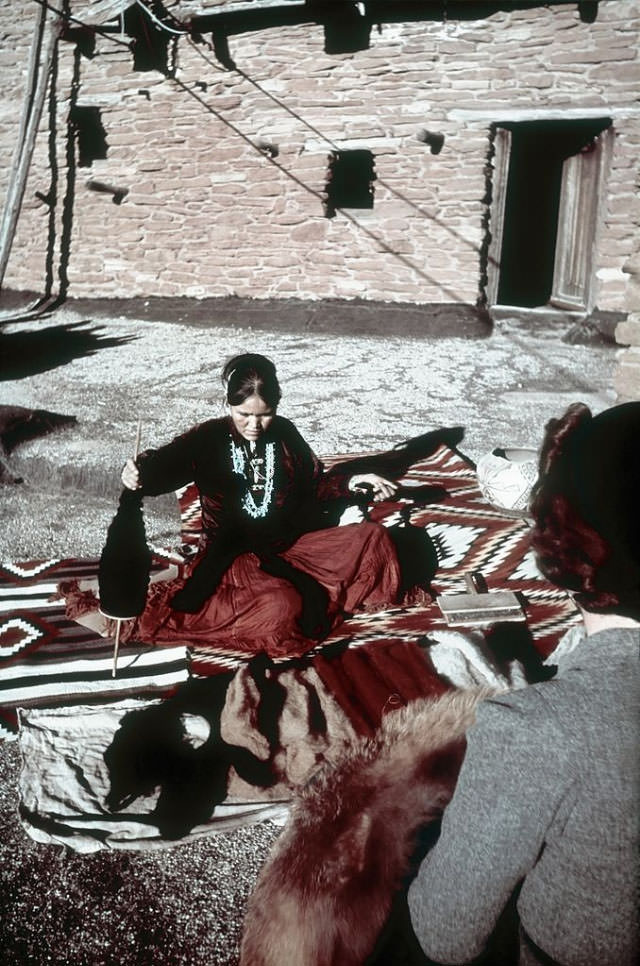 A Native American woman trades pelts.