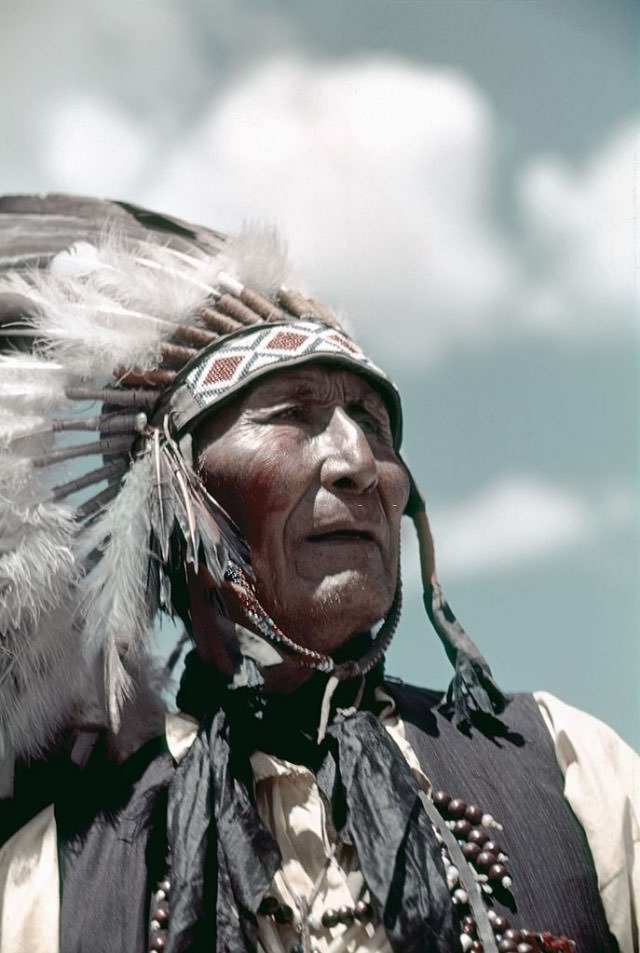 A Native American chief poses for a photo.