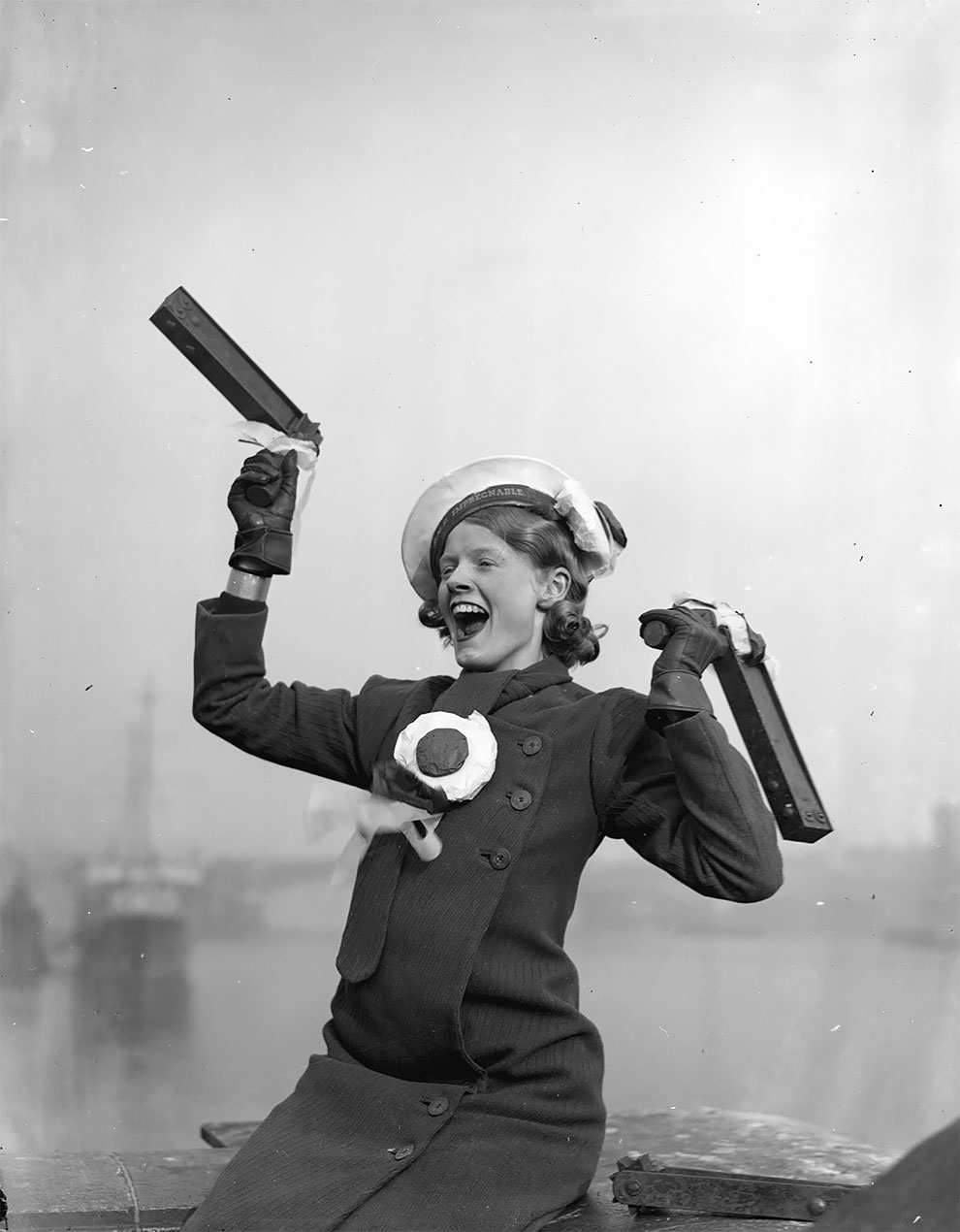 A Portsmouth football fan with a rattle in each hand cheering for her team before their FA Cup final against Manchester City, which the latter won 2-1, 28th April 1934