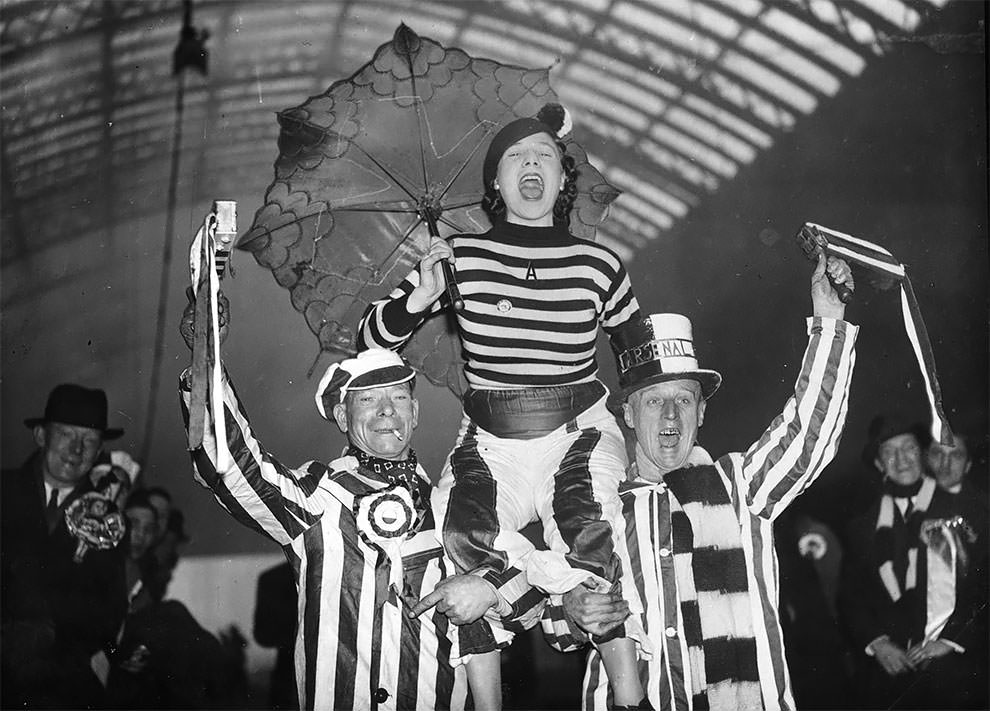 Arsenal football supporters cheering for their team at St. Pancras Station, London, as they make their way to Chesterfield, 16th January 1937