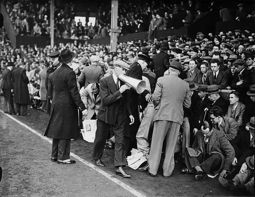 Officials persuading football fans to clear the touch lines before the sixth round FA Cup tie between Brentford and Preston North End at Brentford, Middlesex, 5th March 1938