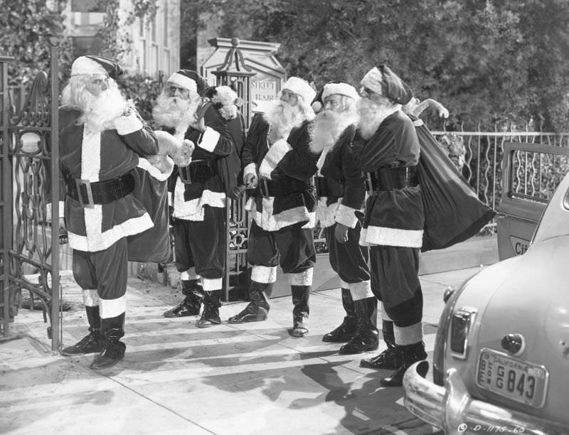 Actor Glenn Ford, left, dressed up as Santa Claus, along with four other actors, for the 1949 film 'Mr Soft Touch.'