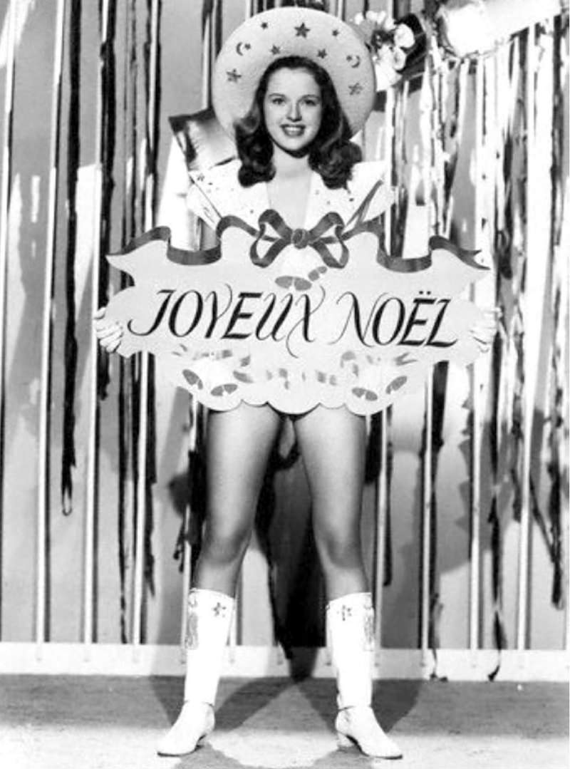 Diana Doris, a British actress, is seen in 1947 with a Christmas greeting written in French.