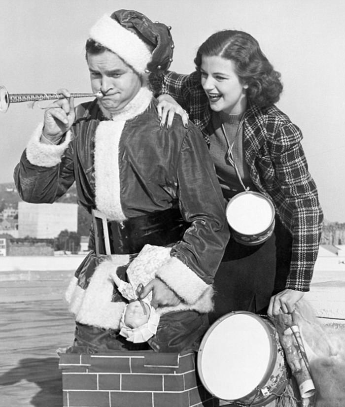 Bob Hope is seen with actress Helen Wood in this 1938 gagshot of him climbing out of a chimney.