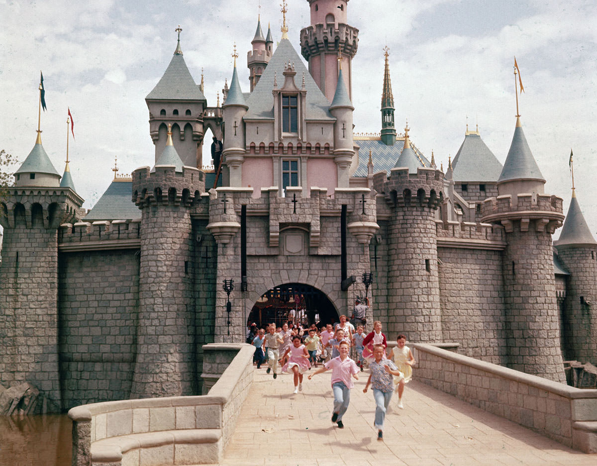 Children run through the gate of Sleeping Beauty's Castle at Disneyland, Walt Disney's theme park, in July 1955. The park opened to the public the week of July 17, 1955.