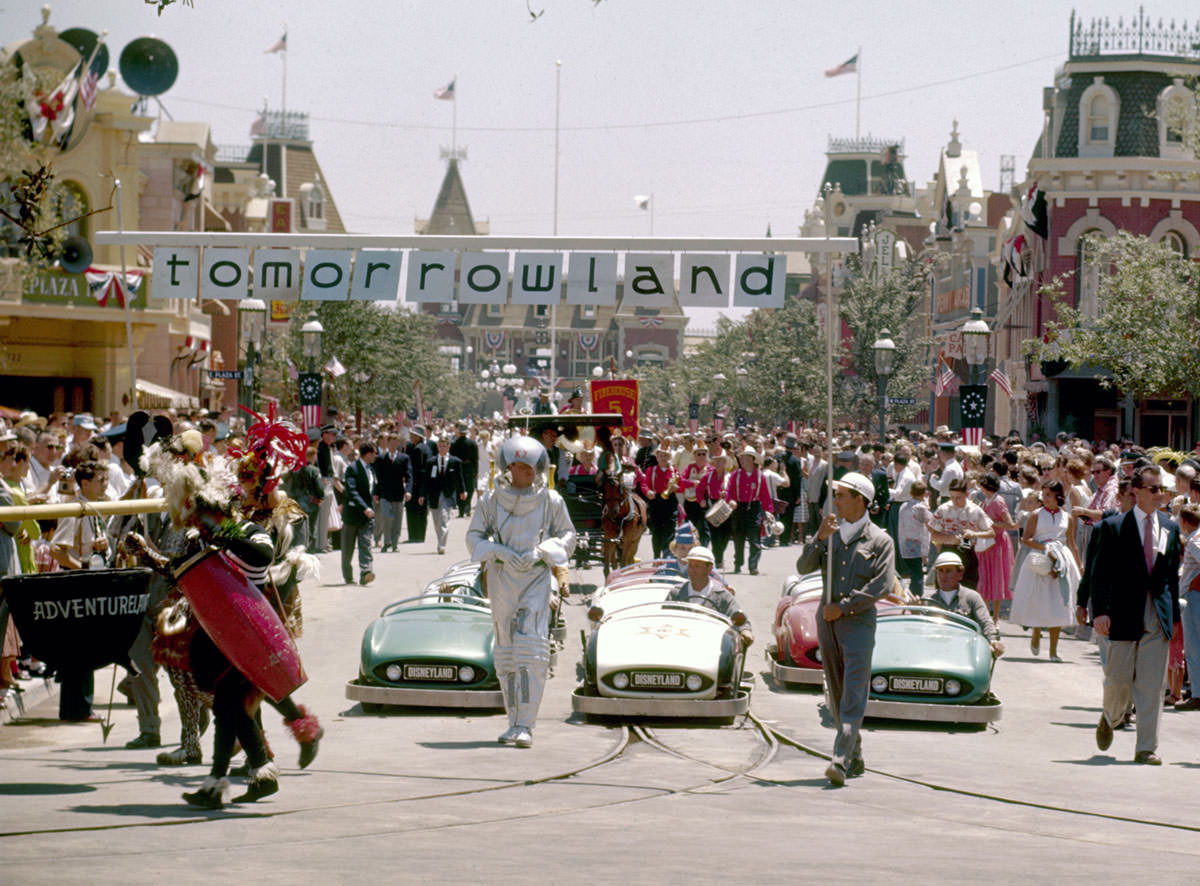 Crowds of people watch the Tomorrowland portion of a parade celebrating the opening of the Disneyland amusement park on July 17, 1955