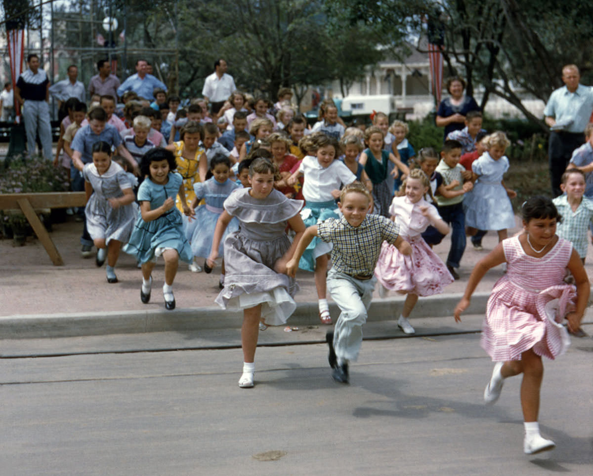 Children run into Disneyland on opening day, July 17, 1955
