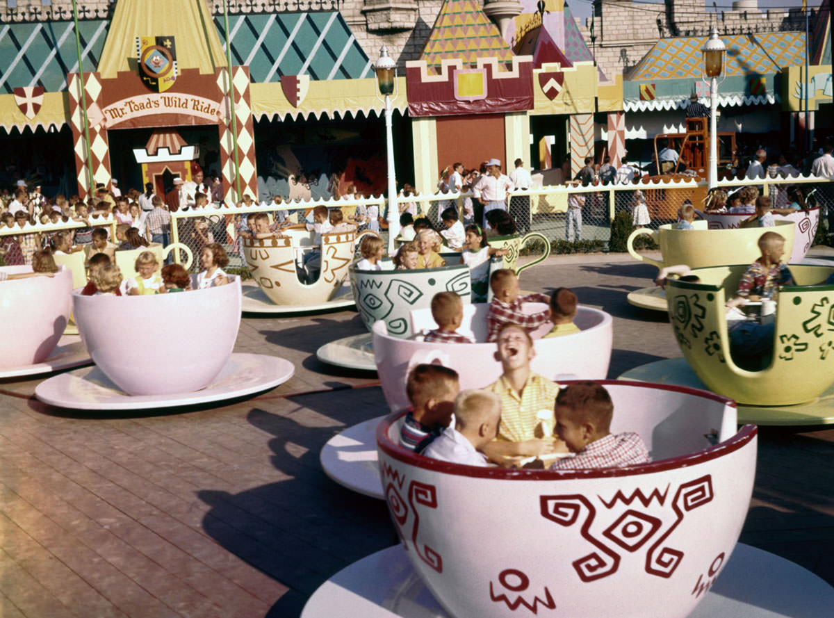 Visitors ride the Mad Hatter's Tea Party attraction in Fantasyland on July 17, 1955