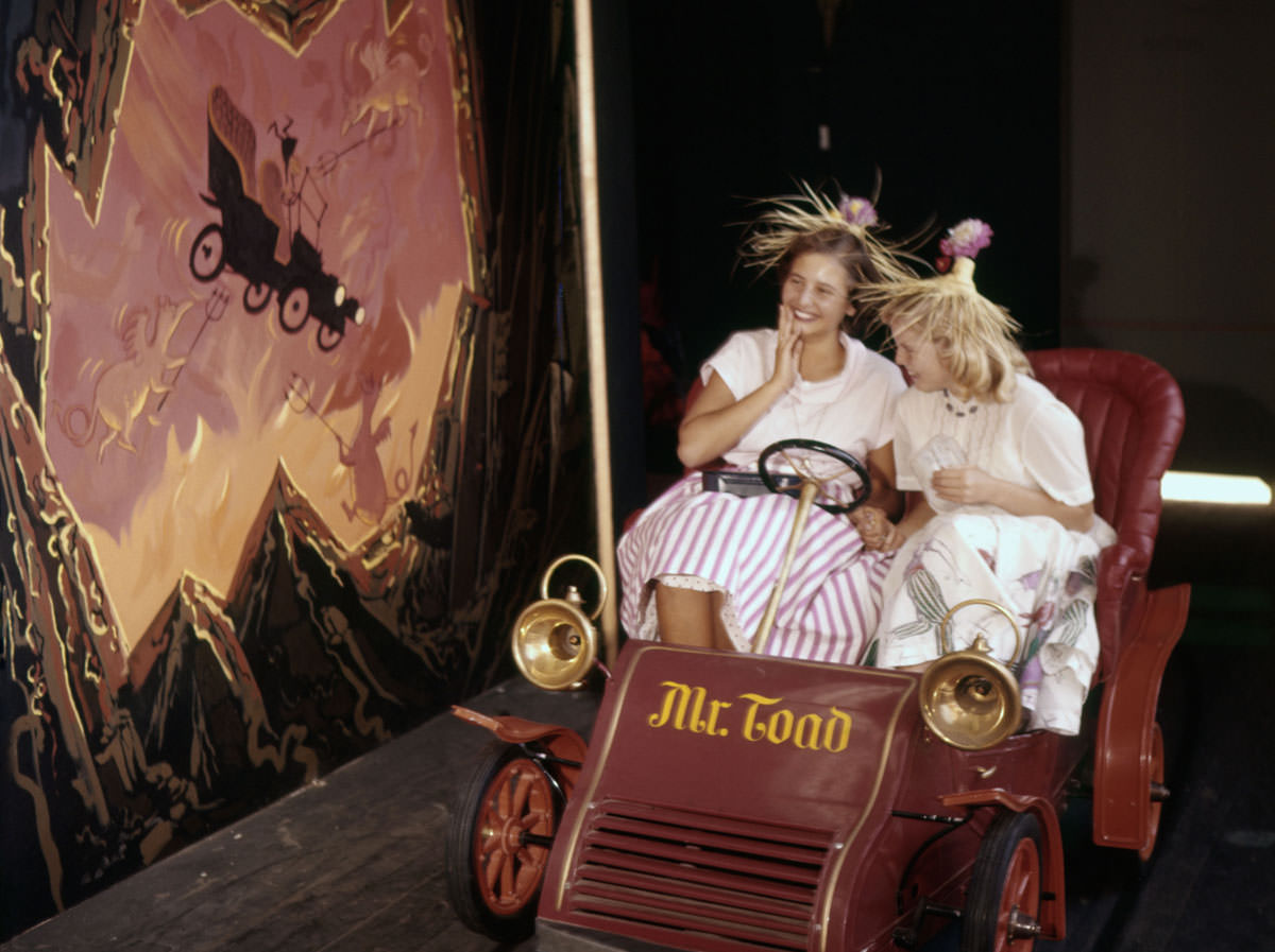 Visitors take a ride on Mr. Toad's Wild Ride at Disneyland on July 17, 1955