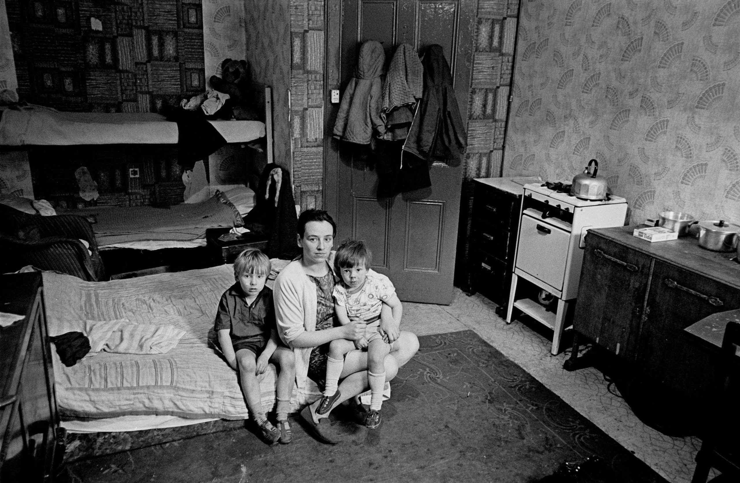 Mother living with her children in an overcrowded single end tenement flat Glasgow 1971