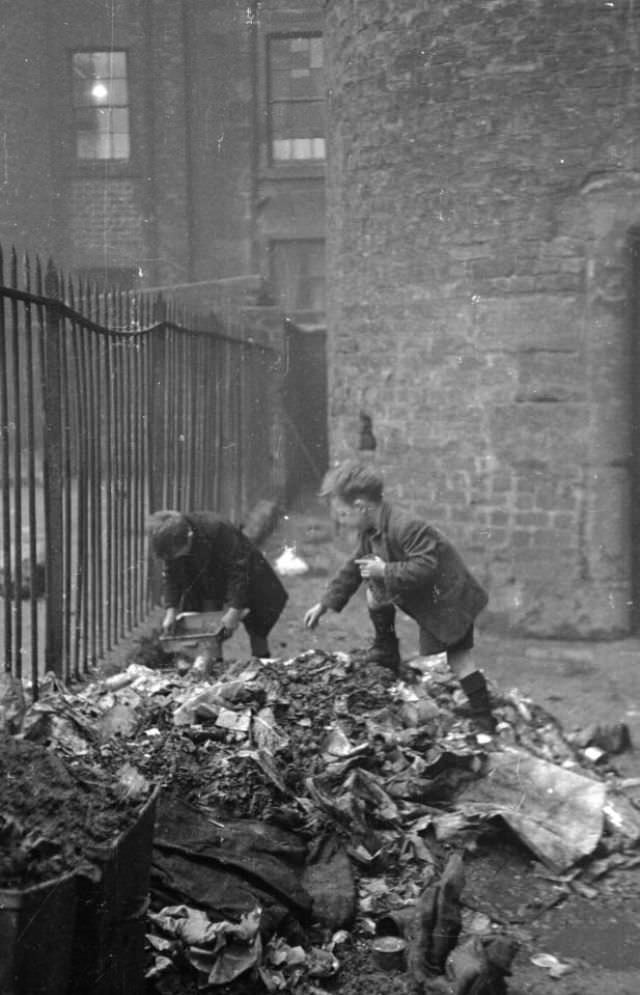 Child eat their breakfast in one of the overcrowded tenement flats, that would sometimes see up to 30 people have to share one toilet