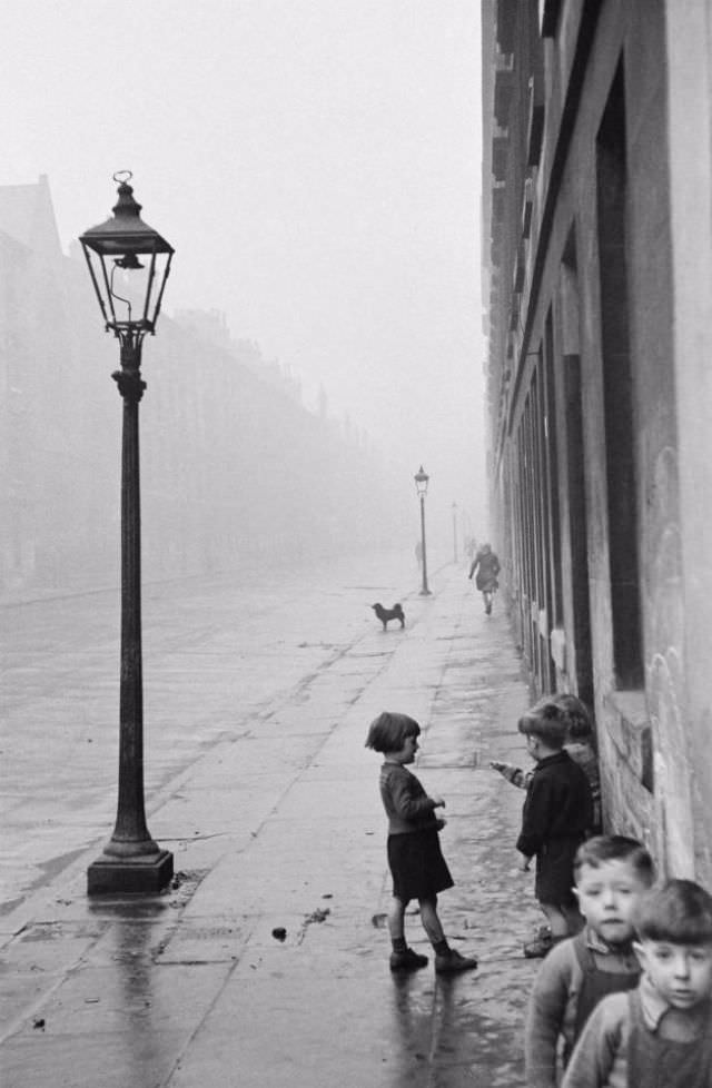 A group of young children on a street in the Gorbals.