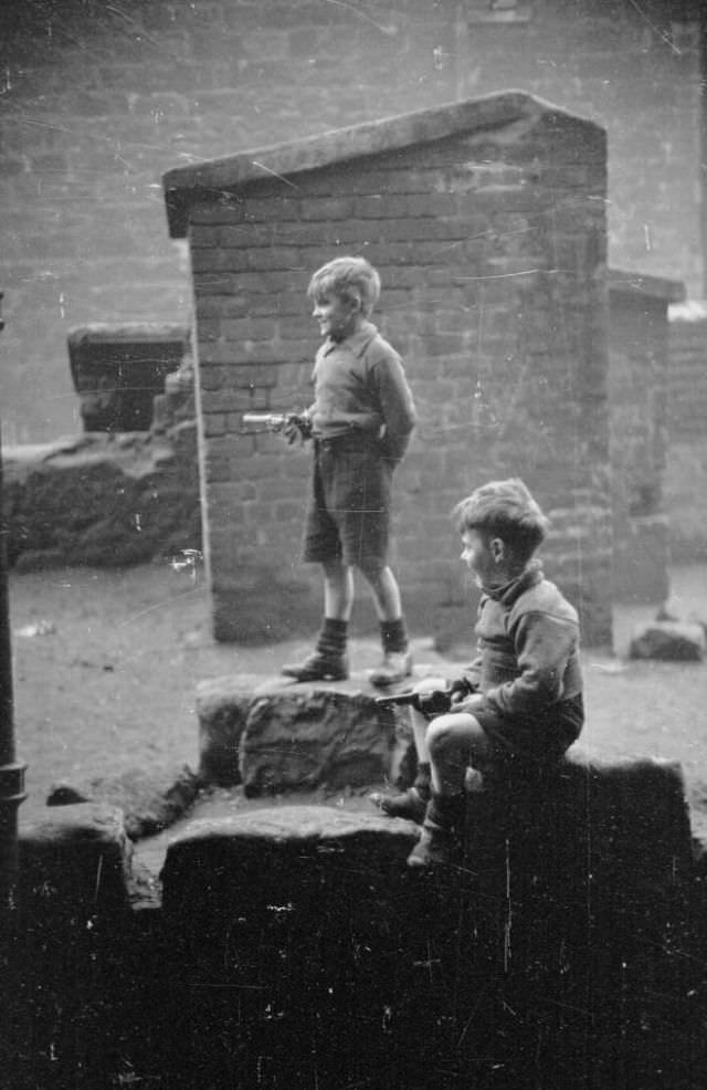 Youngsters play with toy guns around the streets of the huge neighbourhood of tenements