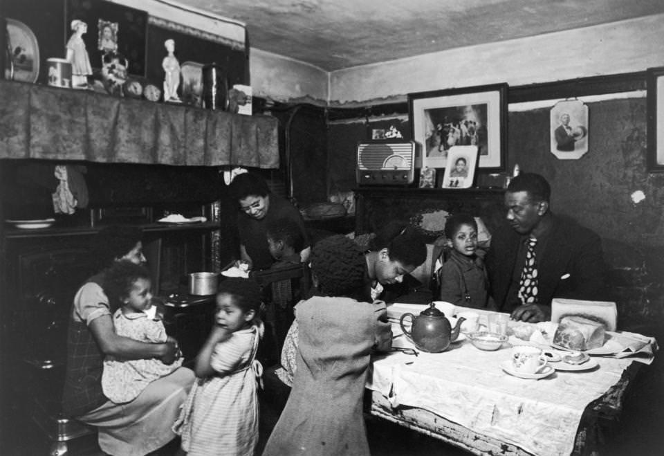 A West Indian family pack into their tiny dining room in the Gorbals