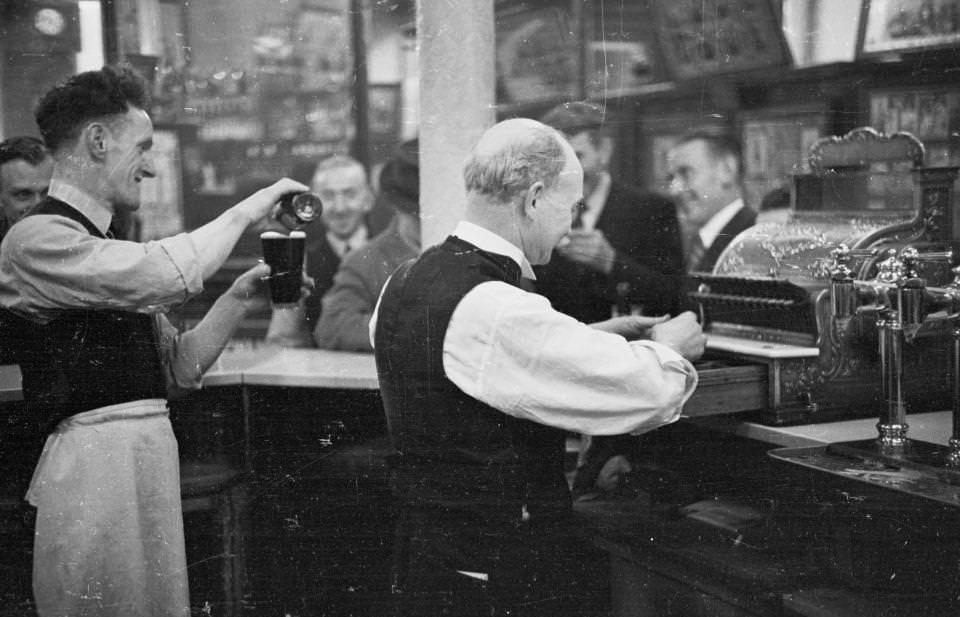 Barmen serve thirsty customers at one of the 174 pubs surrounding the Gorbals area