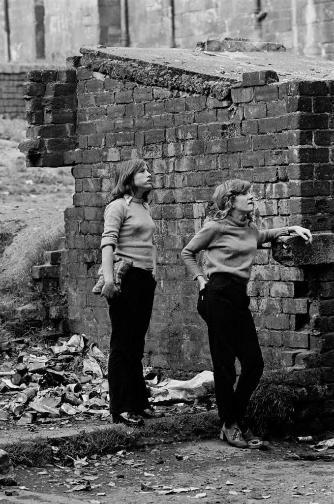 Teenage girls waiting in backyard of tenement block Maryhill 1971
