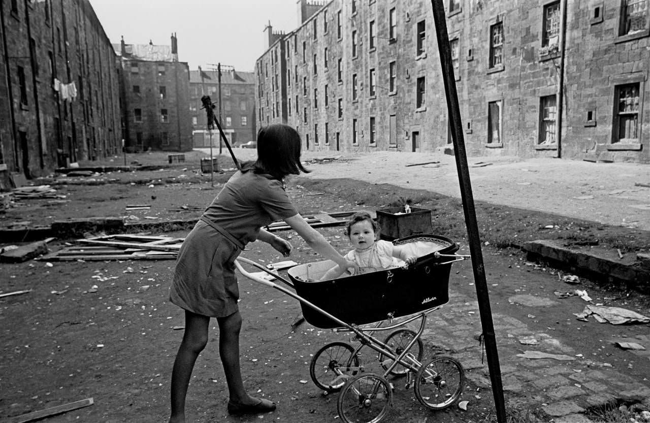 Mother and baby in Gorbals tenement courtyard 1970