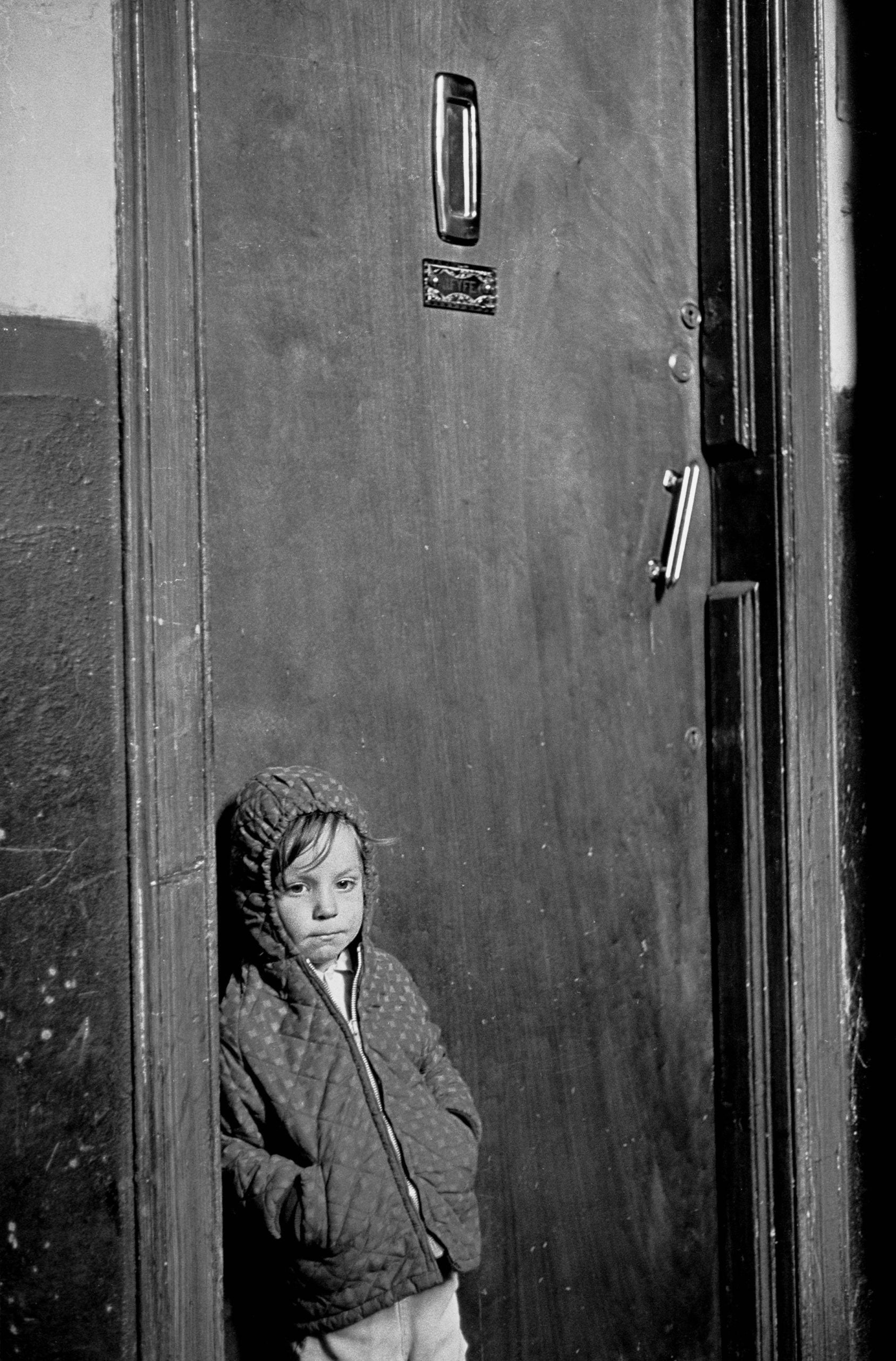 Child waiting for his parents to come home Glasgow tenement 1971