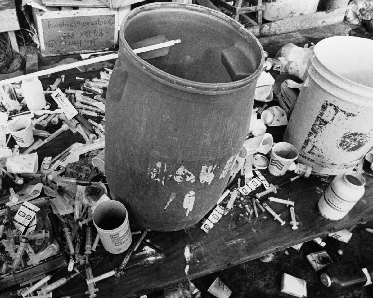 Syringes surround one of the vats used to mix up the position drink used in a mass suicide for 918 people at the religious cult town of Jonestown, Nov. 18, 1978, Guyana.