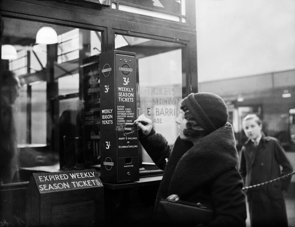 A traveller buys a London Underground season ticket from a vending machine at Highgate Station, 1932.