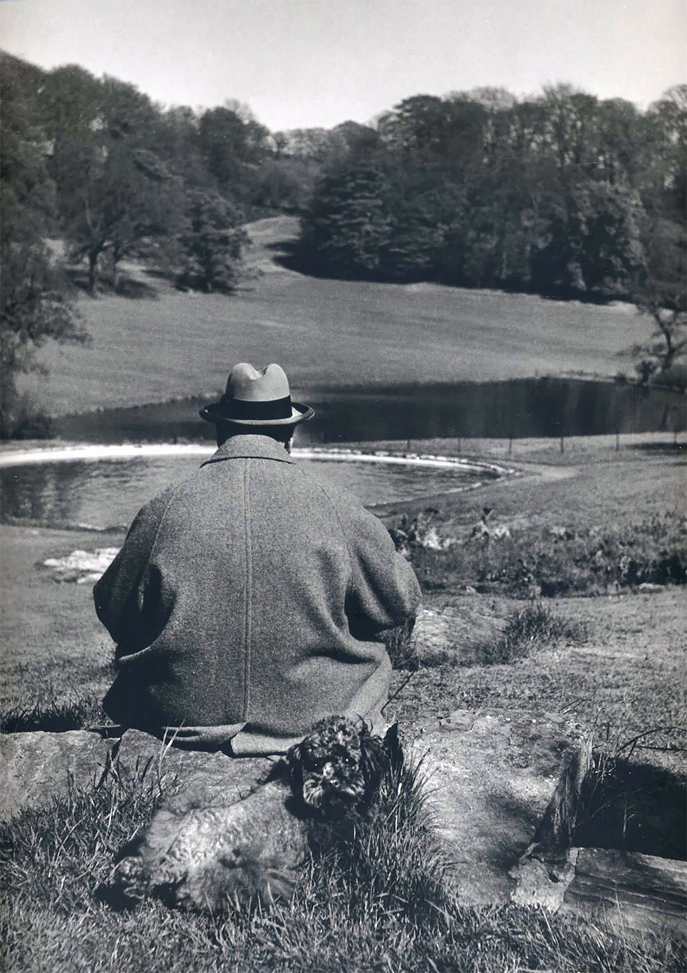British Prime Minister Winston Churchill with his poodle, Rufus, in the gardens of his Chartwell estate, 1951.