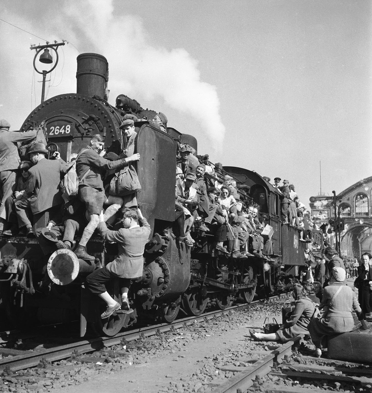 German refugees and displaced persons crowding every square inch of a train leaving Berlin after the war's end. 1945.