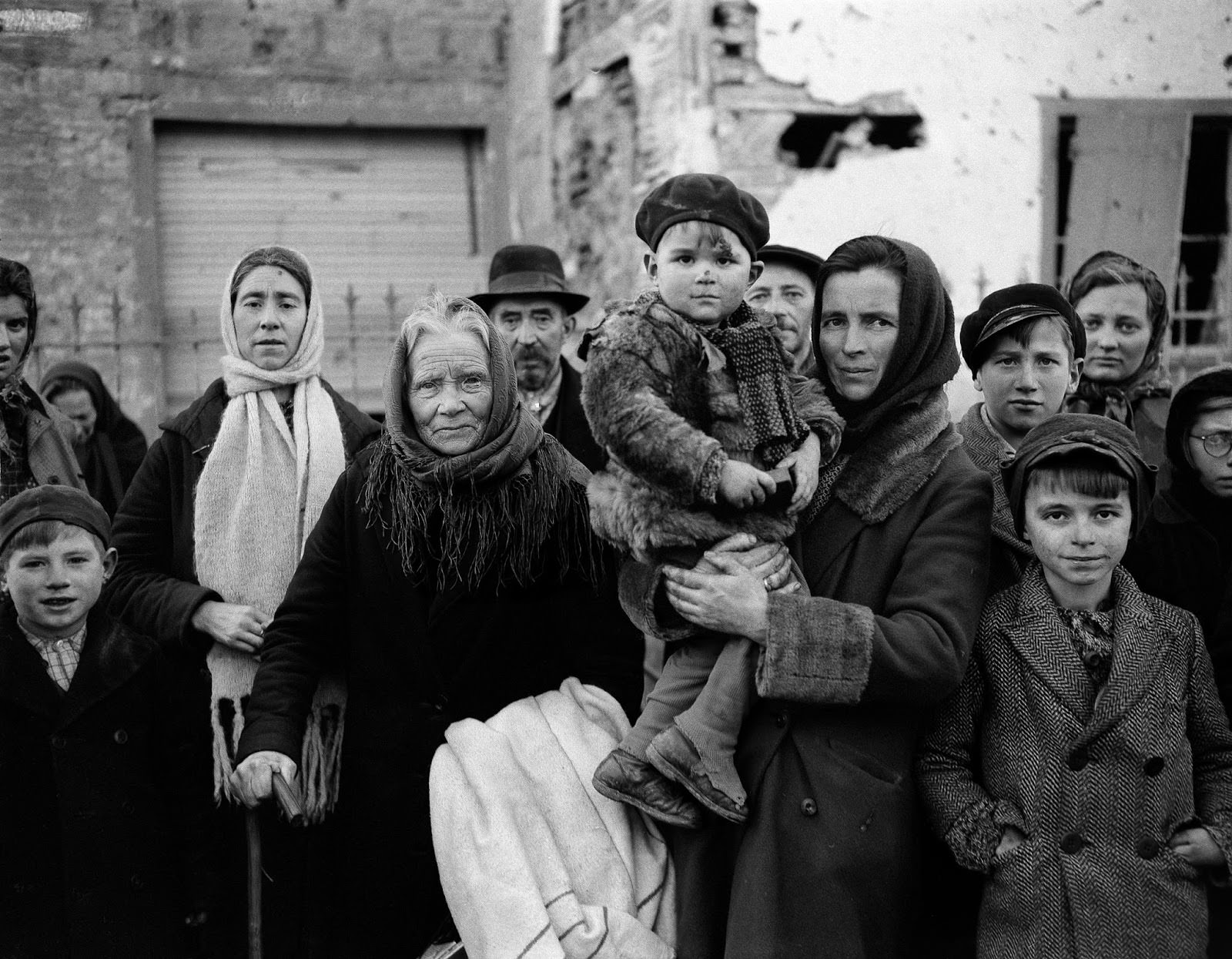 Refugees in La Gleize, Belgium, on Jan. 2, 1945, wait to be transported from the war-torn town after its recapture by American forces during the German thrust into the Belgium-Luxembourg salient.