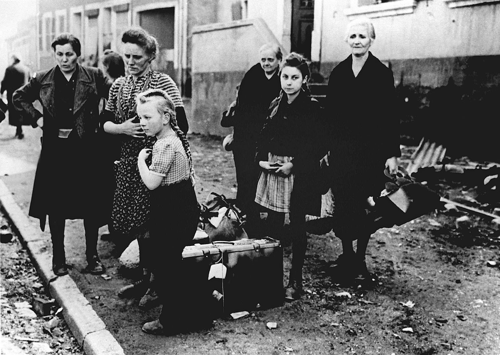 Women and children standing at the roadside in 1945.