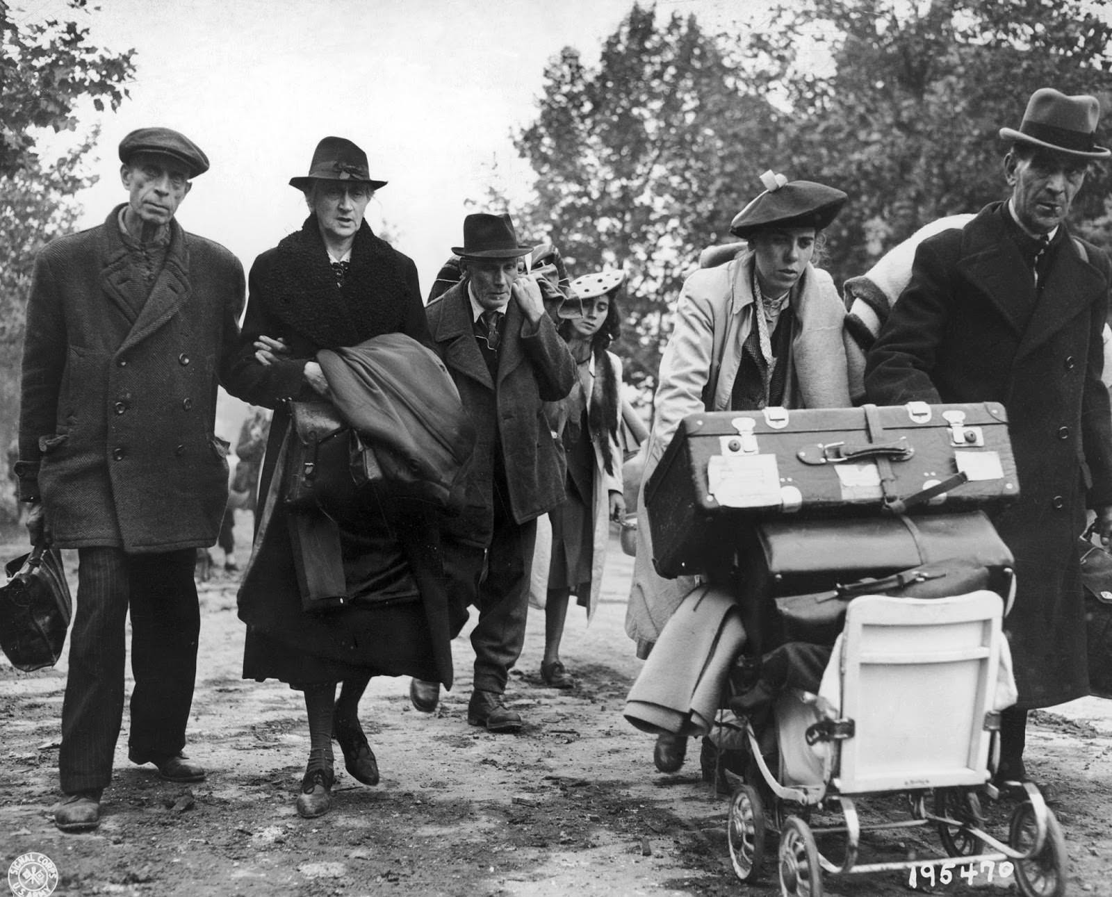 German civilian refugees walking through the streets of Aachen, Germany, on their way to a safer area away from the combat zone, on Oct. 15, 1944.