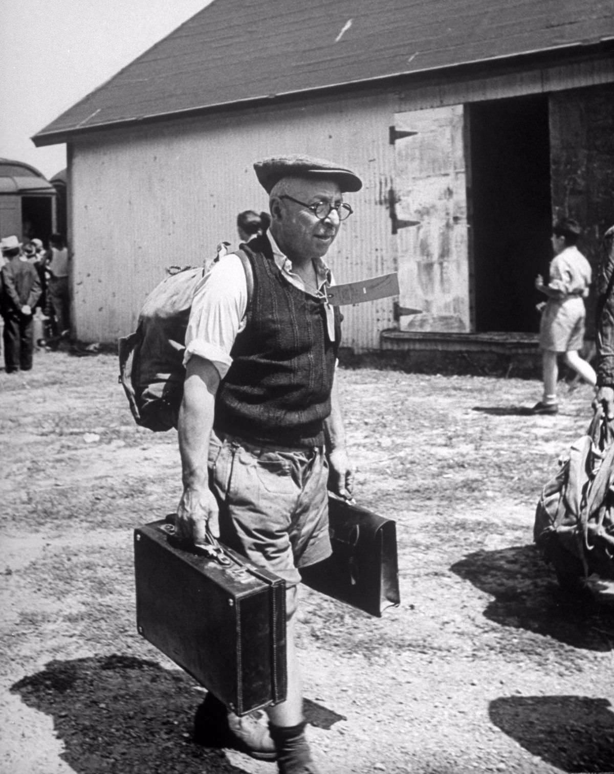 Refugees carried their own luggage to the customs depot. Boys from Oswego were hired to help but many refugees clung to possessions.