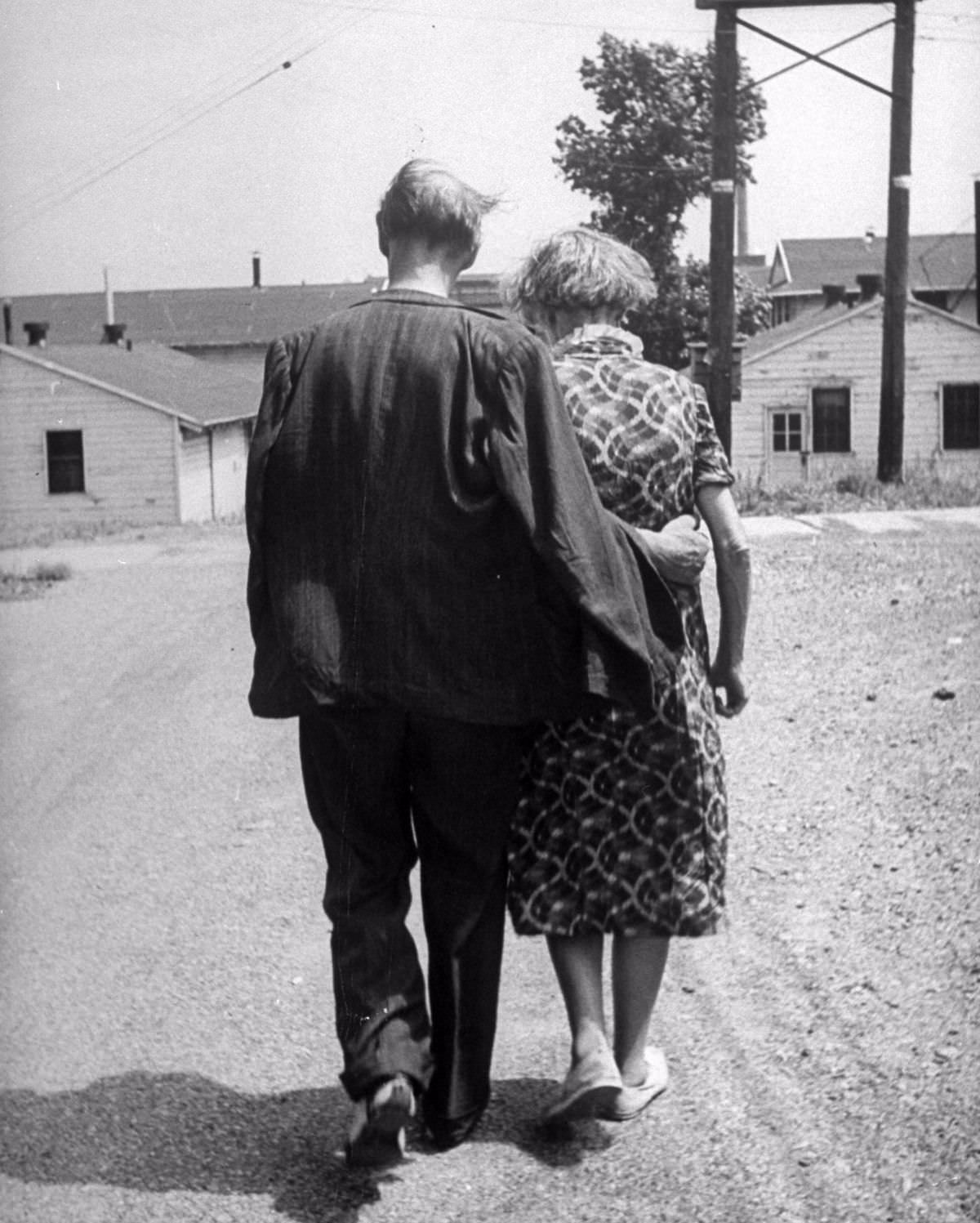 Up camp street, arm in arm, stroll Mr. and Mrs. Michele Mikhailoff, artists from Russia. They walked to the shore of Lake Ontario.