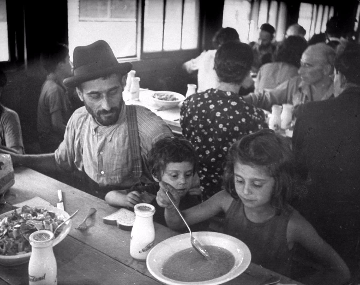 The Dresdner family, mother, father and nine children, were confined in two concentration camps in France. In September 1943 they made their escape to Italy. Here a hungry daughter, not knowing quite how to eat gravy, simply pitches in.