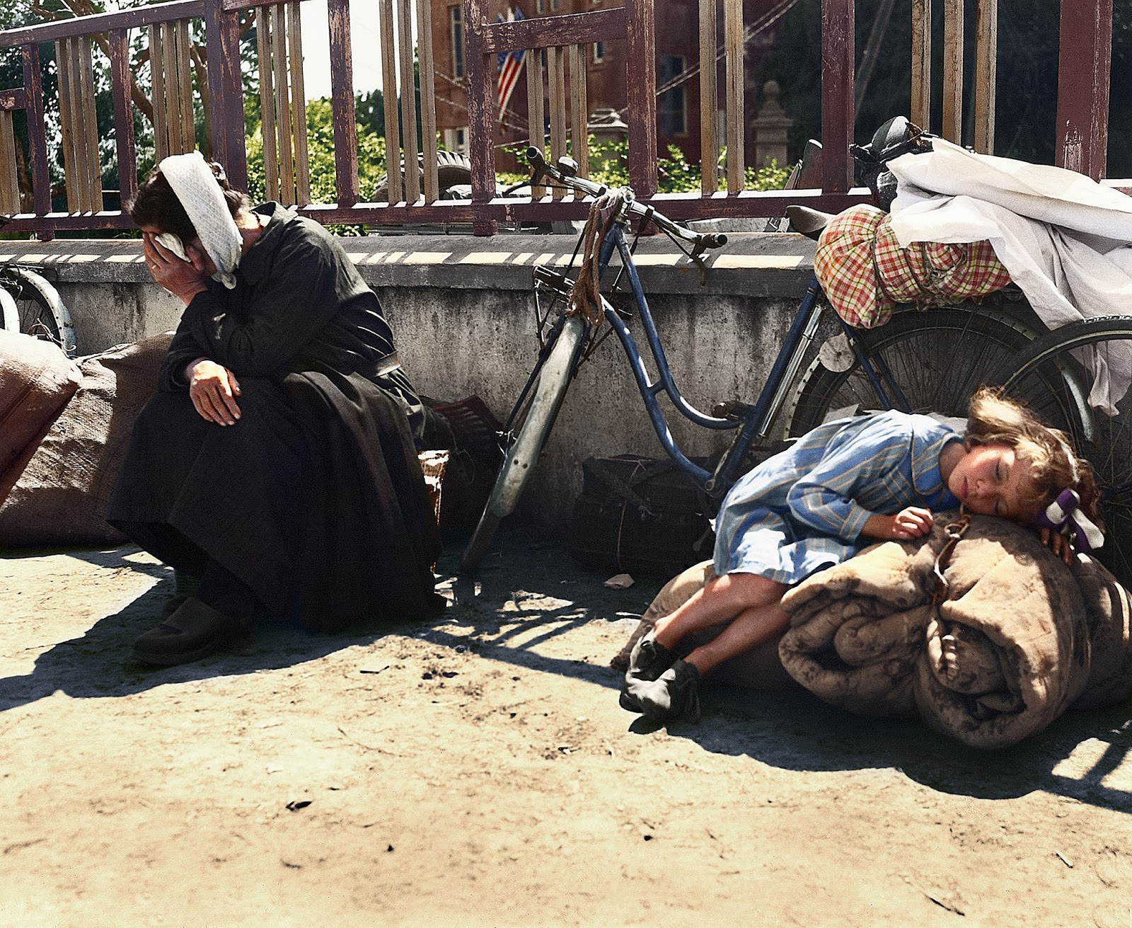 French refugees, returning to their homes in St. Pois, France after the Germans were driven out by the American forces, stop to rest at the side of the road on August 10, 1944.